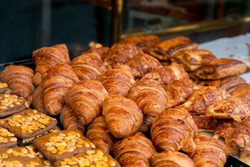 Stack of freshly baked pastry products displayed at a bakery shop