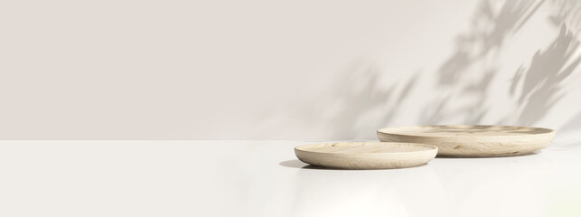 Two minimal modern wooden round tray podium on white glossy table counter in sunlight, leaf shadow...