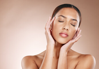 Skincare, beauty and relax, woman with eyes closed and facial massage on studio background. Makeup,...