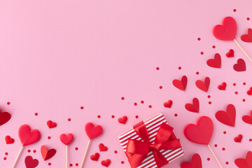 Saint Valentine day background with gift box and various red hearts. Flat lay style greeting composition. - 559079046