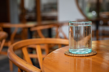 Glass of water in cafe. Beautiful interior of Bali style cafe in Ubud, Bali, Indonesia