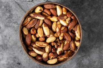 Brazil nut on dark background. Brazil nut in bowl. Studio shoot. Top view