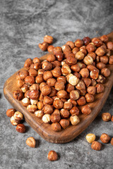 Nuts on a wood serving board. A pile of nuts. Studio shoot. close up