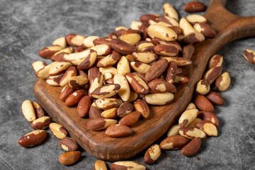 Brazil nuts on a wood serving board. Brazil nut pile. Studio shoot. close up