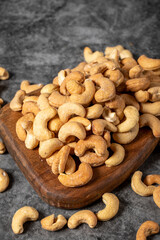 Cashew on wood serving board. A pile of cashews. Studio shoot. close up