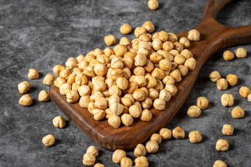 Roasted hazelnuts on a wooden serving board. A pile of nuts. Studio shoot. close up
