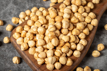 Roasted hazelnuts on a wooden serving board. A pile of nuts. Studio shoot. close up