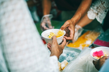 The concept of humanitarian assistance: sharing food to the poor.