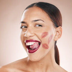 Beauty, makeup and lipstick on a happy woman with tongue on teeth for cosmetics mockup on a studio background. Face of aesthetic model with a smile, glow and color on healthy skin with dermatology