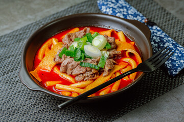 Tteokbokki, Stir-fried Rice Cake : Sliced rice cake bar (garaetteok) or thin rice cake sticks (Tteokbokkitteok) stir-fried in a spicy gochujang sauce with vegetables and fish cakes.