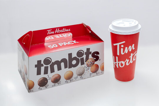 Calgary, Alberta, Canada. Jan 6, 2023. A 50 pack of Timbits with a Extra large Tim hortons coffee cup.