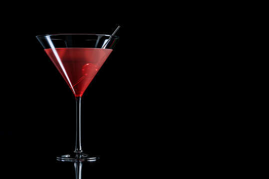 Cosmopolitan cocktail with cherry in martini glass