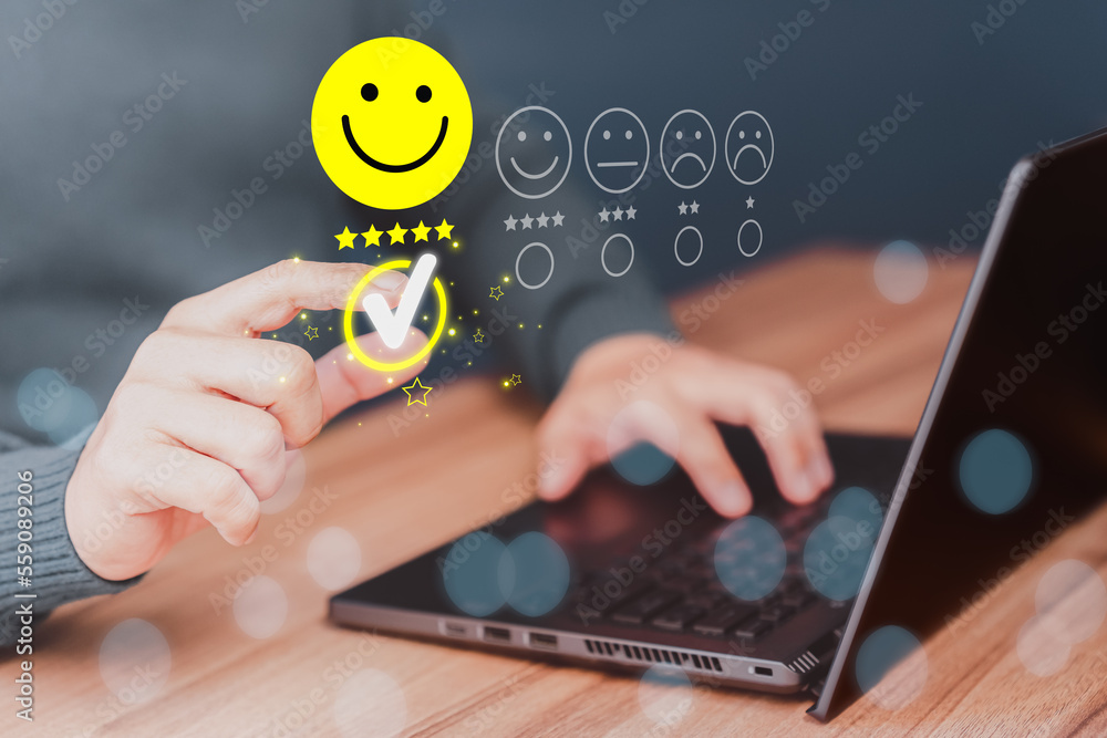 Poster Man hand using computer laptop with popup five star icon for feedback review satisfaction service, testimonial. Customer service experience and business satisfaction survey.
