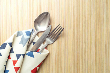 Dinner table backdrop with spoon fork and knife in a patterned fabric