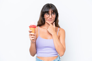 Young caucasian woman with a cornet ice cream over isolated white background thinking