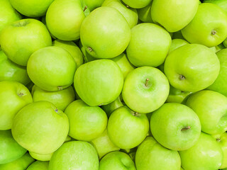 Background of juicy, ripe fruits. Green apples, close-up. Natural background. View from above. Copy space