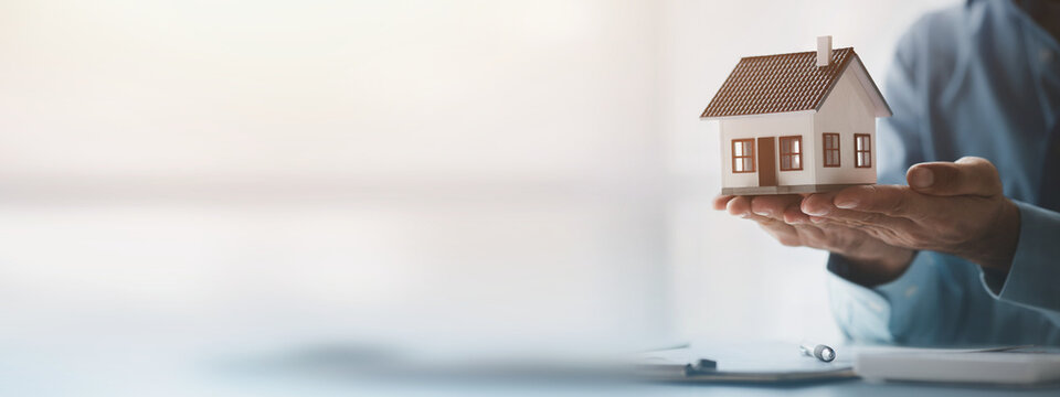 Real estate agents explain models of housing estates in projects to elaborate to clients, explaining and presenting information about homes and purchasing loans. Real estate trading concept.