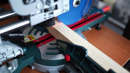 cutting wood with a miter saw. construction tool at work