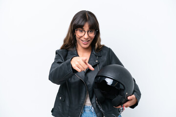 Young caucasian woman with a motorcycle helmet isolated on white background surprised and pointing front