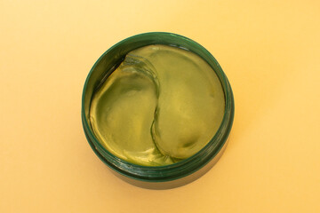 Under eye patches with collagen on beige background.