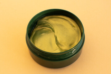 Under eye patches with collagen on beige background.