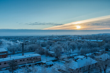 Scenic top view of snow-covered houses on a winter morning.