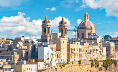 Fototapeta na wymiar View of Valletta rooftops and Church of Our Lady of Mount Carmel and St. Paul's Anglican Pro-Cathedral, Valletta, capital of Malta 
