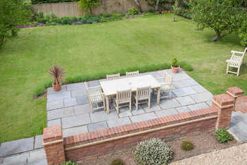 Large UK back garden with patio furniture on terrace