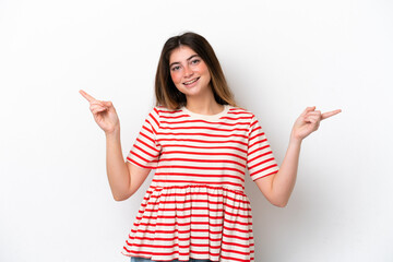 Young caucasian woman isolated on white background pointing finger to the laterals and happy