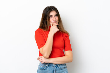 Young caucasian woman isolated on white background having doubts