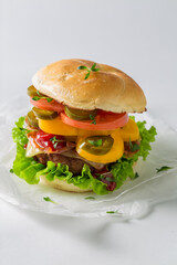 Tasty and fresh hamburger with bacon, tomato and beef