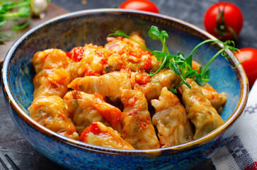 Homemade Cabbage rolls with meat, rice and vegetables also known as sarma, golubtsy, dolma on Rustic Background