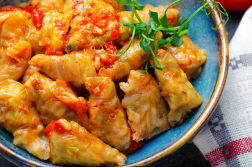 Homemade Cabbage rolls with meat, rice and vegetables also known as sarma, golubtsy, dolma on Rustic Background