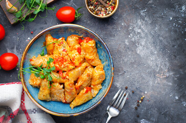Homemade Cabbage rolls with meat, rice and vegetables also known as sarma, golubtsy, dolma on Rustic Background
