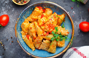 Homemade Cabbage rolls with meat, rice and vegetables also known as sarma, golubtsy, dolma on Rustic Background
