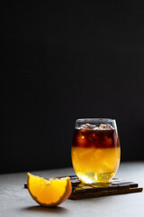 Bumble coffee with layers of espresso, orange juice and syrup on a dark background.