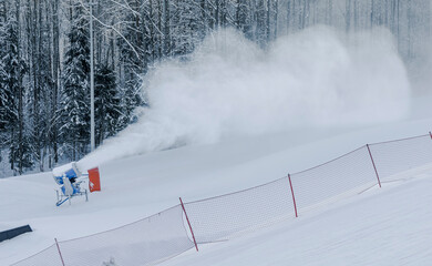 snow by forcing water and pressurized air through a "snow gun", also known as a "snow cannon"