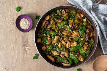 Stir fry chicken, green peas and green beans. Top view. Asian style