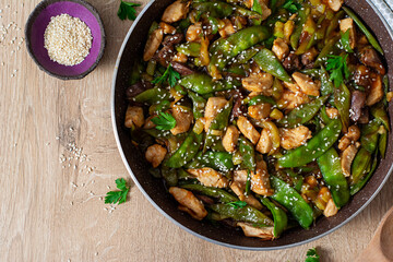 Stir fry chicken, green peas and green beans. Top view. Asian style