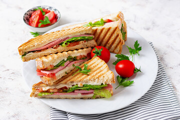 Club sandwich panini with ham, tomato, cheese and lettuce. Top view