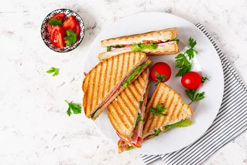 Fotobehang Club sandwich panini with ham, tomato, cheese and lettuce. Top view © timolina