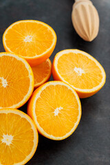 Fresh orange halves on a dark background. Juicy citrus fruits for making juice