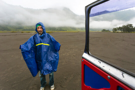 Man in rain coat with volcanic dust,Bromo,Java,Indonesia