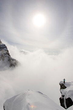 skier looking out over clouds and mountains, British Colombia