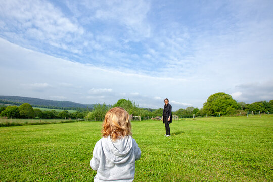 a little boy and his mom having fun on a green field in the country side, Caurel Brittany, France.