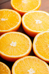 Orange halves on a wooden table. Orange slices close-up