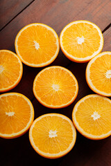 Orange halves on a wooden table. Orange slices close-up