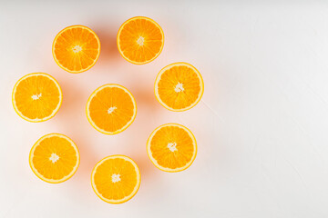 Fresh ripe oranges on a white background. Halves of juicy oranges for vegan