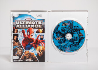 Obraz premium Kent, england 01.01.2023 Nintendo wii marvel ultimate alliance game on a white isolated background. iconic retro vintage video gaming machine. Japanese technology family gaming fun.