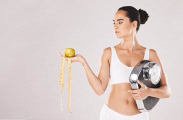 Fitness, health and woman with scale and apple for weightloss, diet and nutrition on white studio...